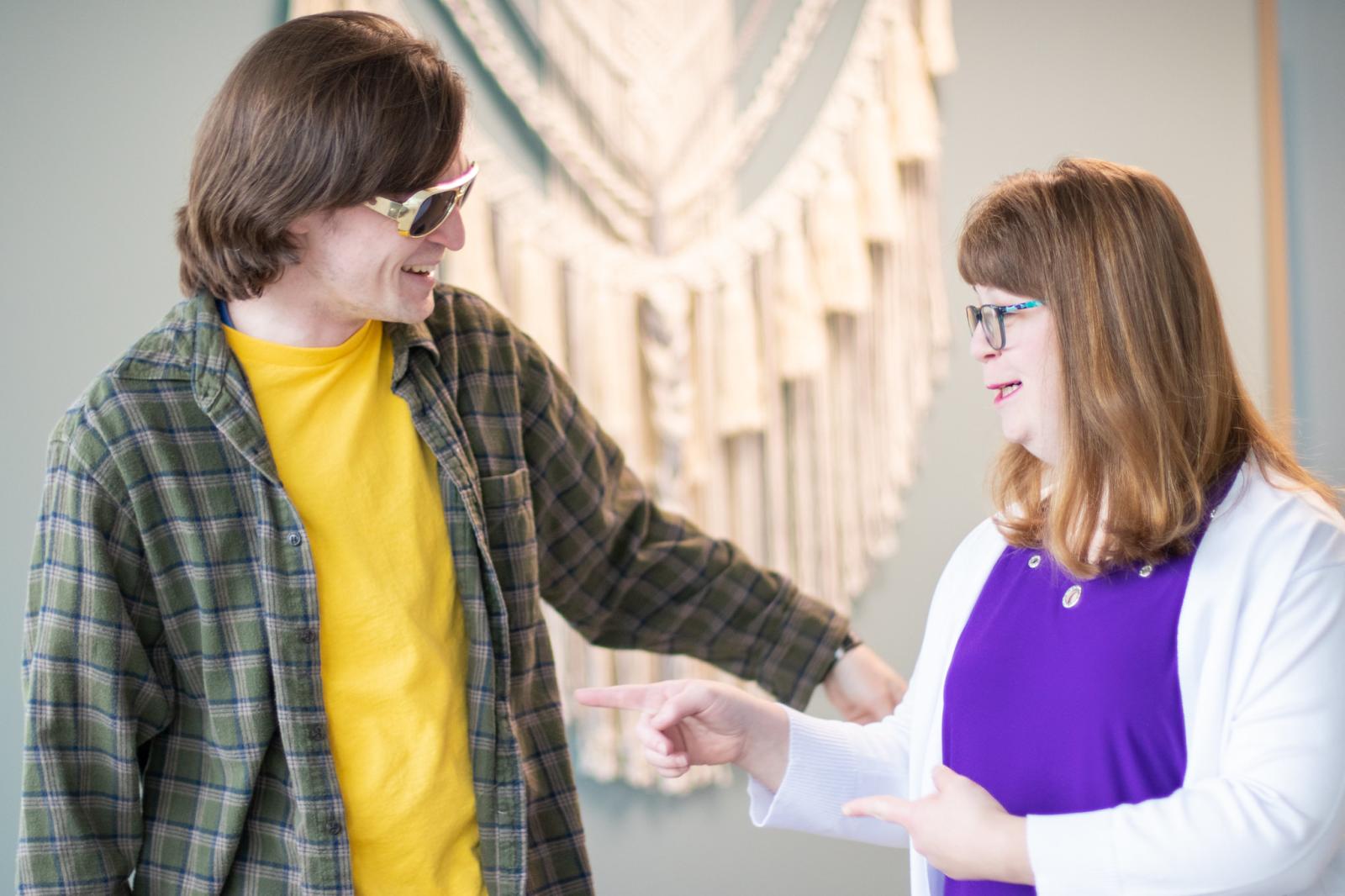 two people with disabilities that are wearing sunglasses