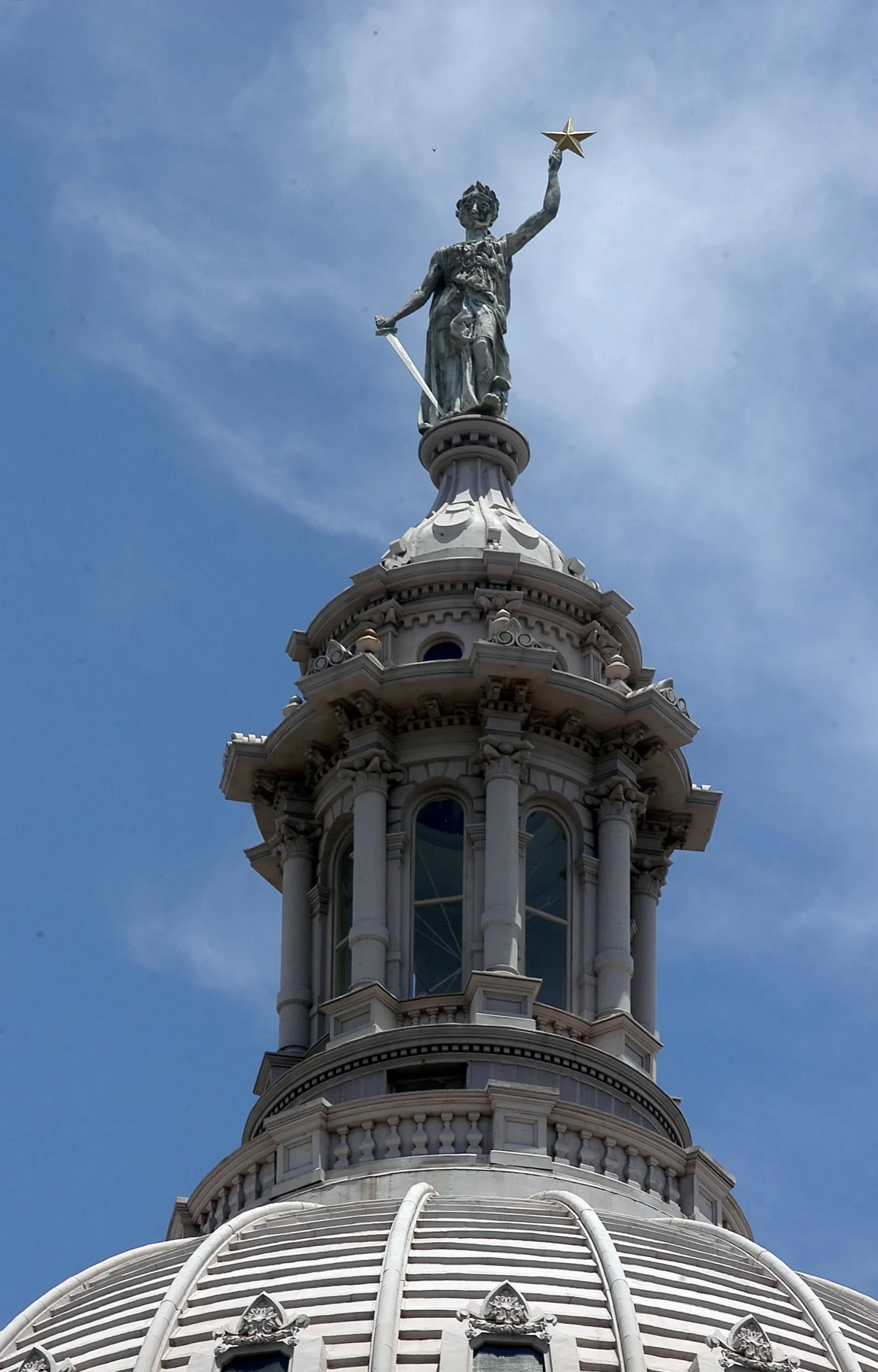 capitol dome with a statue holding a bird and sword