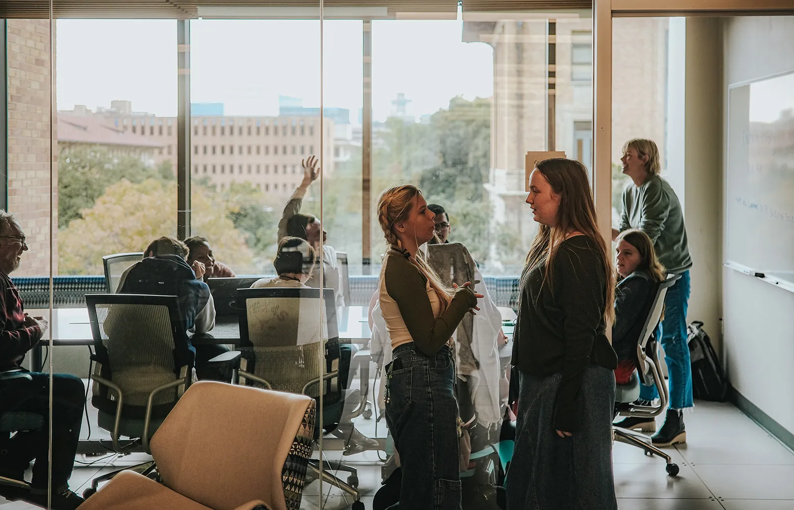 students chatting outside a classroom.