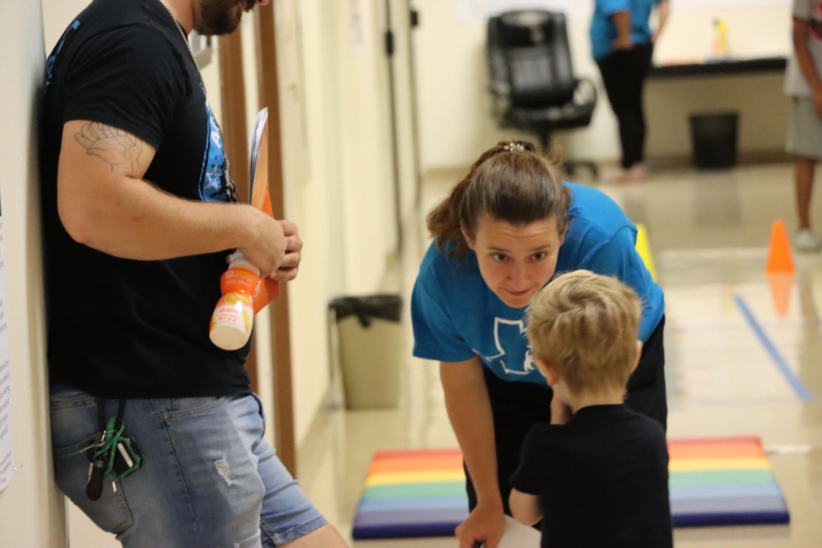 TCDS staff member talking to a kiddo about their screening