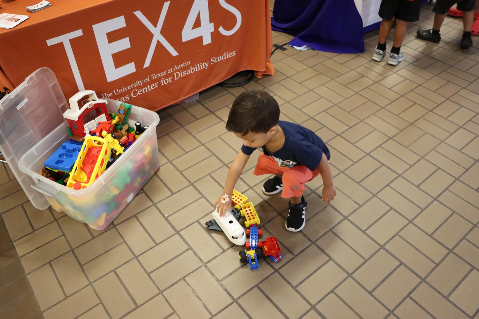 child playing with toys in front of the E4 table