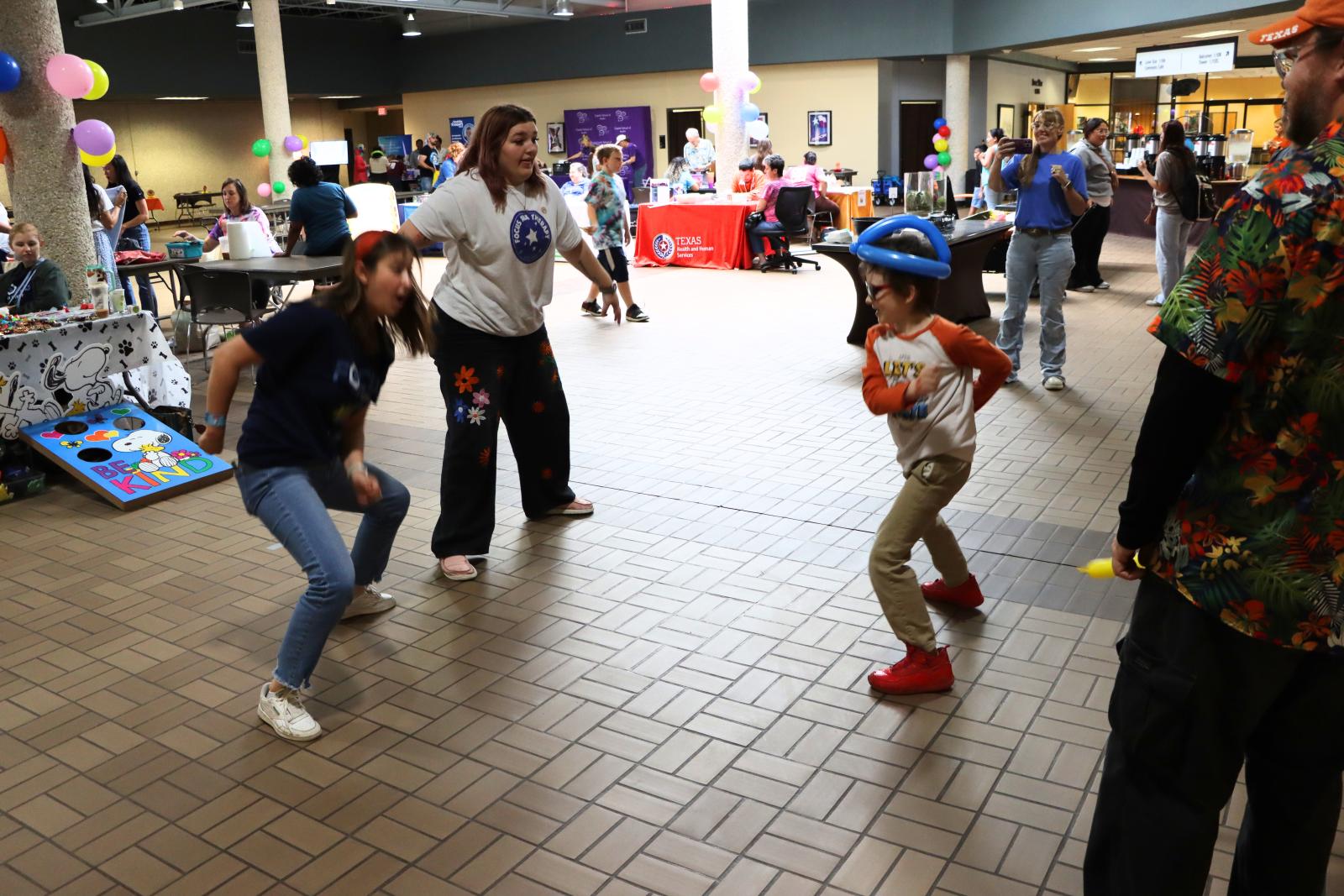 kid dancing with vendors at the screening event