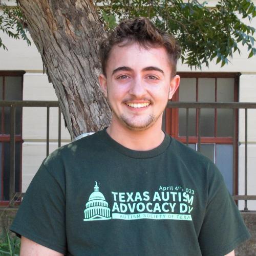 Aiden has short cropped brown hair. He wears a green Texas Autism Advocacy Day shirt.