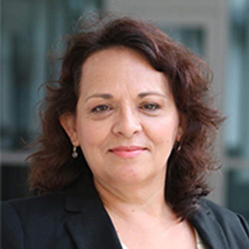 Profile image of Deborah Parra-Medina. Deborah wears a black blazer. She has dark, reddish-brown hair and small earrings.