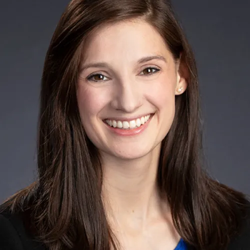 Lauren Hampton, white woman with brown straight hair, wide smile