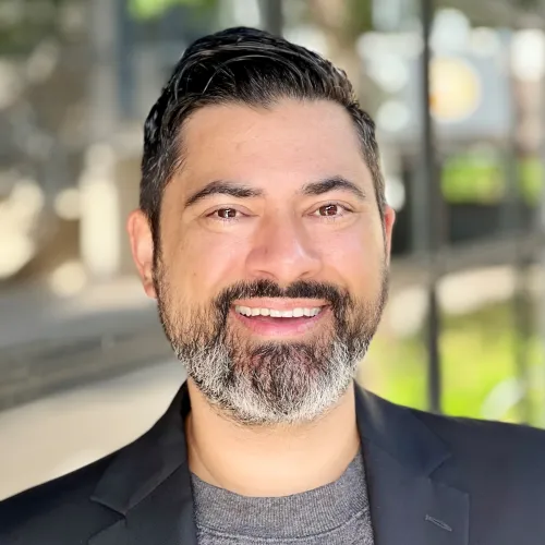 headshot of Jeffrey - salt and pepper beard with darker hair