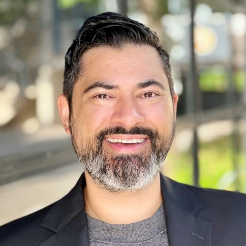 headshot of Jeffrey - salt and pepper beard with darker hair