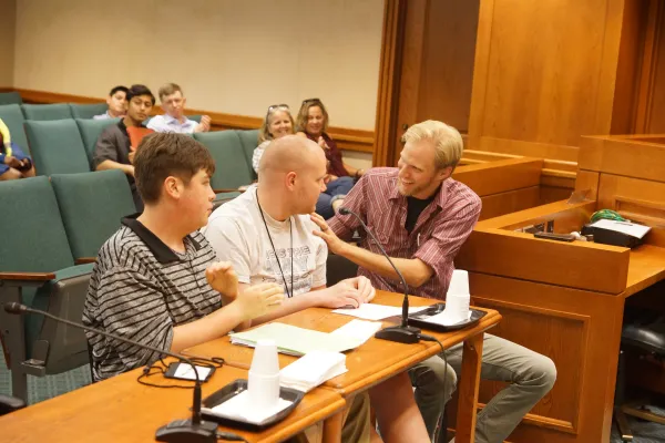Photo of 3 people sitting at Austin Capitol presenting