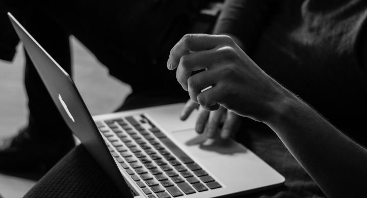 hands typing on a laptop