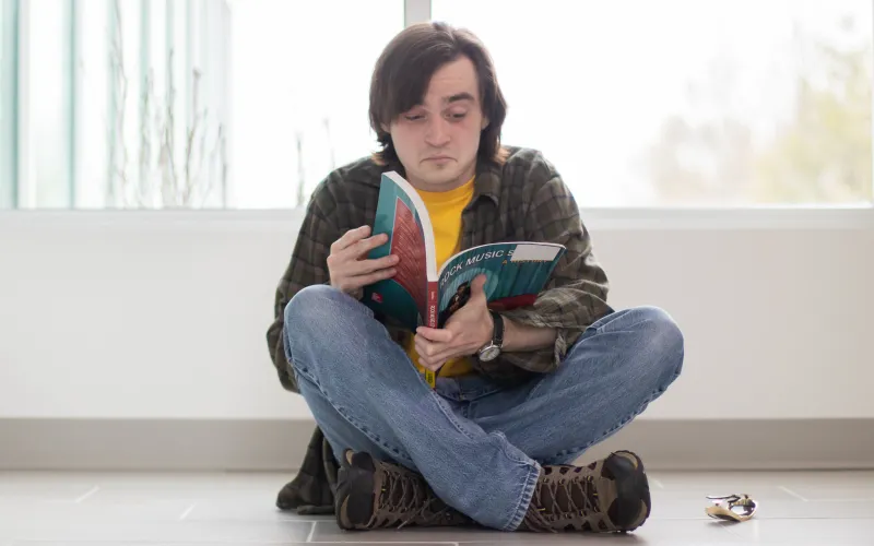 a student reading from a music textbook