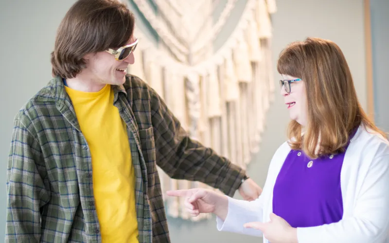 two people with disabilities that are wearing sunglasses